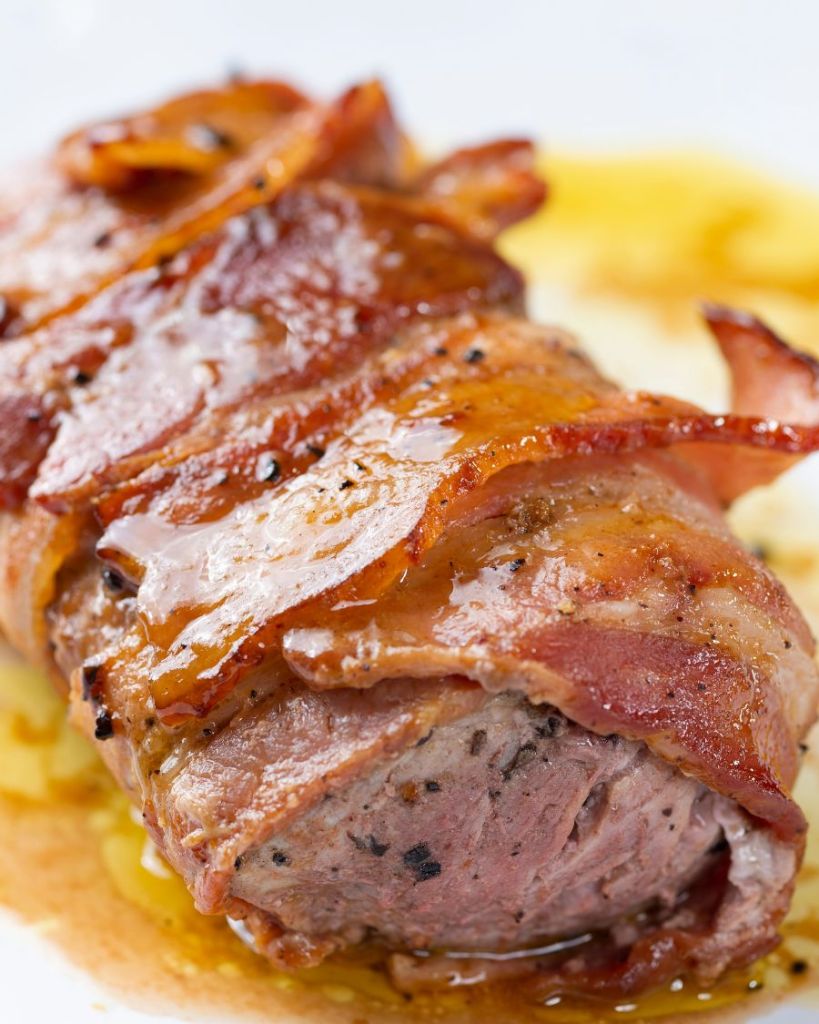 Wrapped in crispy bacon, these juicy, herbaceous Bacon Wrapped Pork Chops are so easy to make in your oven! A couple of simple secrets in this easy recipe guarantee perfect results every time. Perfect date night or dinner party main course.