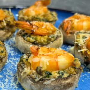 Baked shrimp stuffed mushrooms with creamy spinach filling and parmesan topping