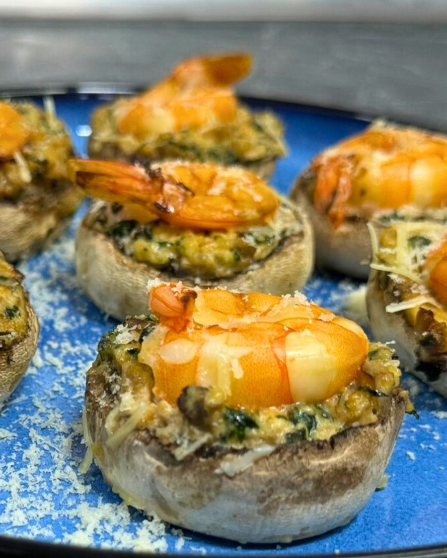 Baked shrimp stuffed mushrooms with creamy spinach filling and parmesan topping
