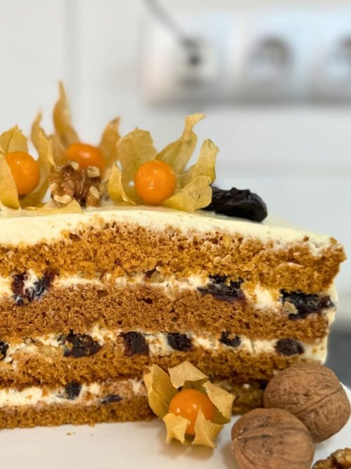 Layered honey bun cake with creamy filling, walnuts, and dried plums – Russian honey cake recipe