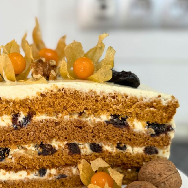 Layered honey bun cake with creamy filling, walnuts, and dried plums – Russian honey cake recipe