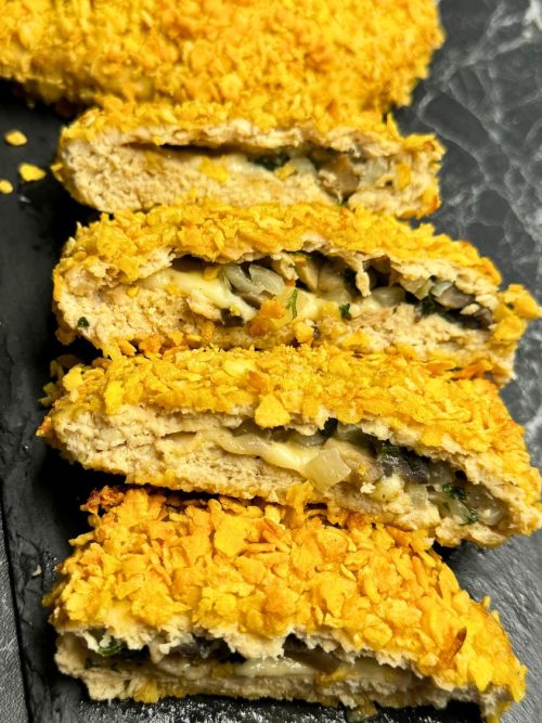 Sliced baked chicken pockets with crispy cornflake crust and cheesy mushroom filling