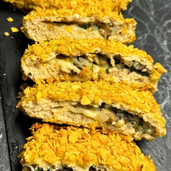 Sliced baked chicken pockets with crispy cornflake crust and cheesy mushroom filling