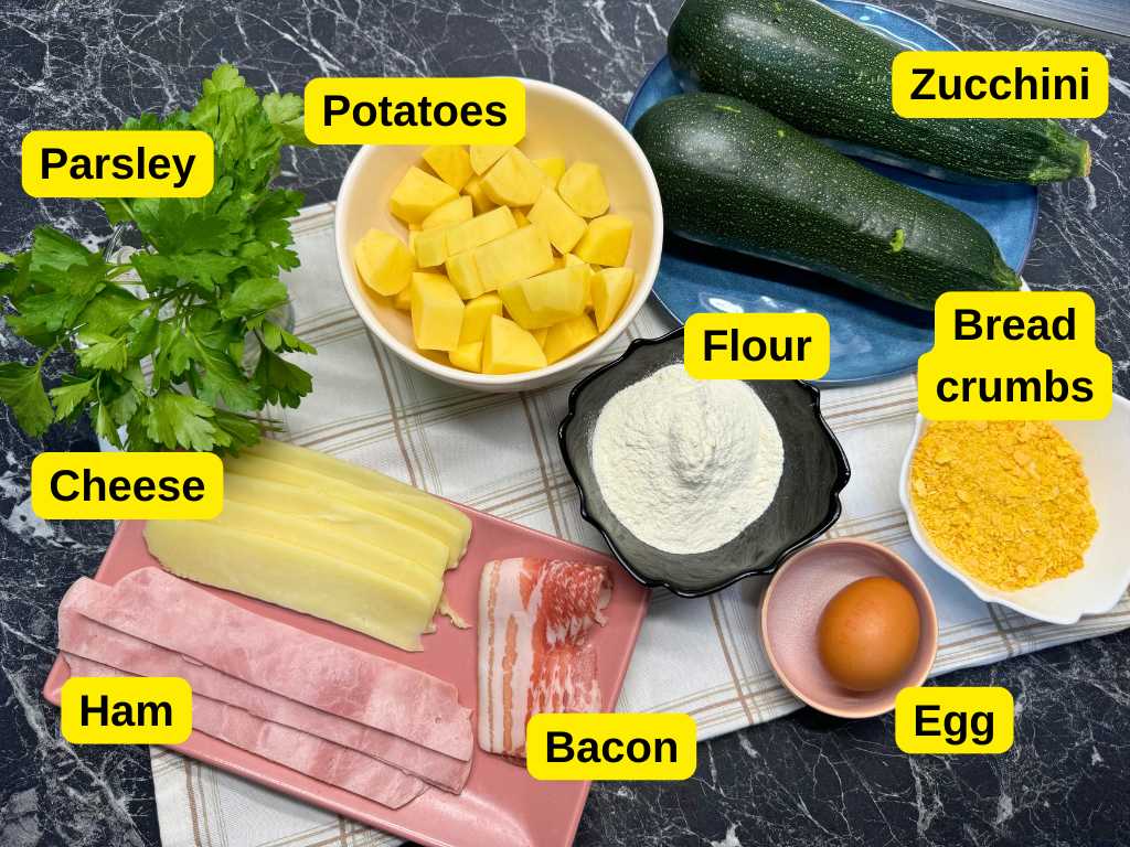 Labeled ingredients for zucchini roll skewers: fresh zucchini, chopped potatoes, parsley, flour, bread crumbs, egg, ham, cheese, and bacon