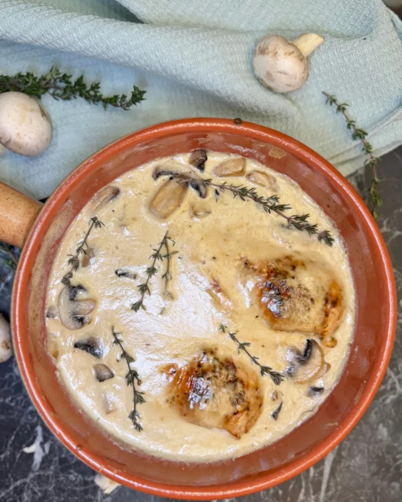 oven baked chicken breast in creamy mushroom sauce with herbs and golden top