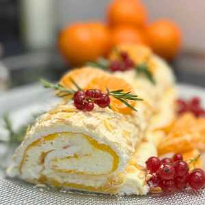 Slice of mandarin meringue roll with creamy filling and citrus curd