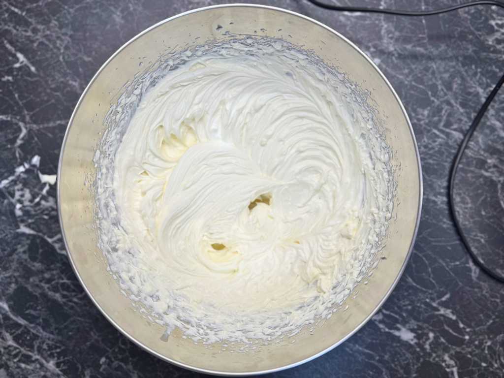 Whipped cream cheese and cream filling prepared for mandarin meringue roll