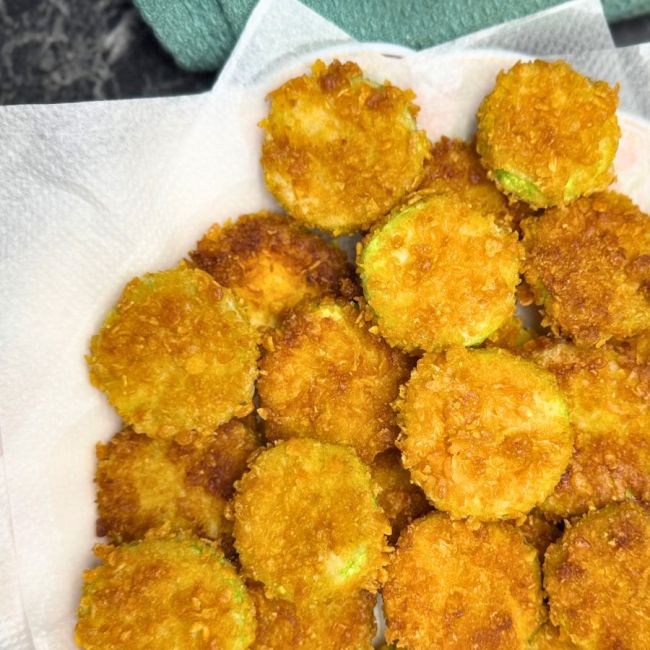 a plate full of crispy fried zucchini