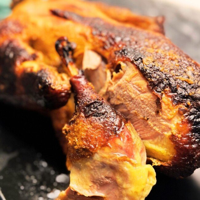 Oven roasted whole duck with crispy skin and caramelized honey soy glaze ready to serve