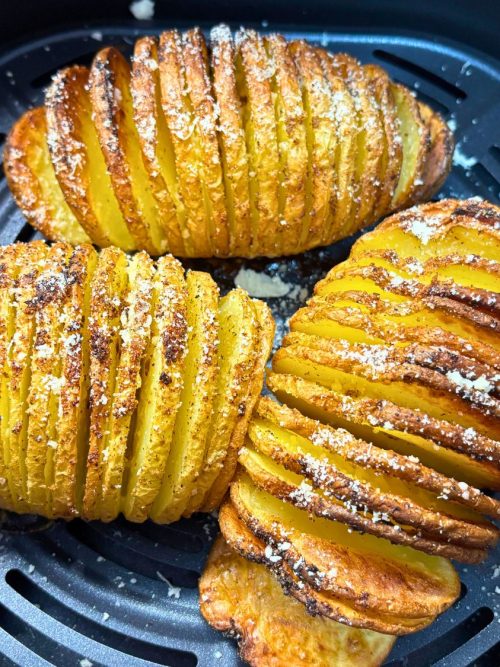 Crispy golden Parmesan Hasselback potatoes cooked in the air fryer, sliced thin and sprinkled with cheese and seasoning