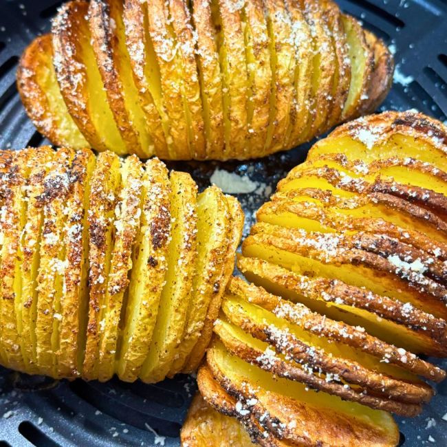 Crispy golden Parmesan Hasselback potatoes cooked in the air fryer, sliced thin and sprinkled with cheese and seasoning