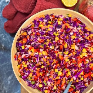 Antioxidant raw vegetable salad with red cabbage, pomegranate, corn, and carrots