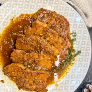 Braised pork in dark beer garnished with thyme and served in aromatic sauce