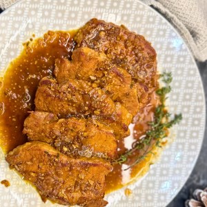 Braised pork in dark beer garnished with thyme and served in aromatic sauce