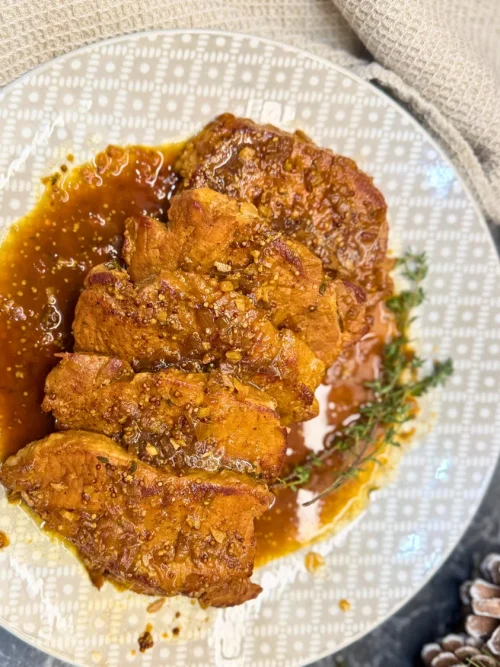 Braised pork in dark beer garnished with thyme and served in aromatic sauce