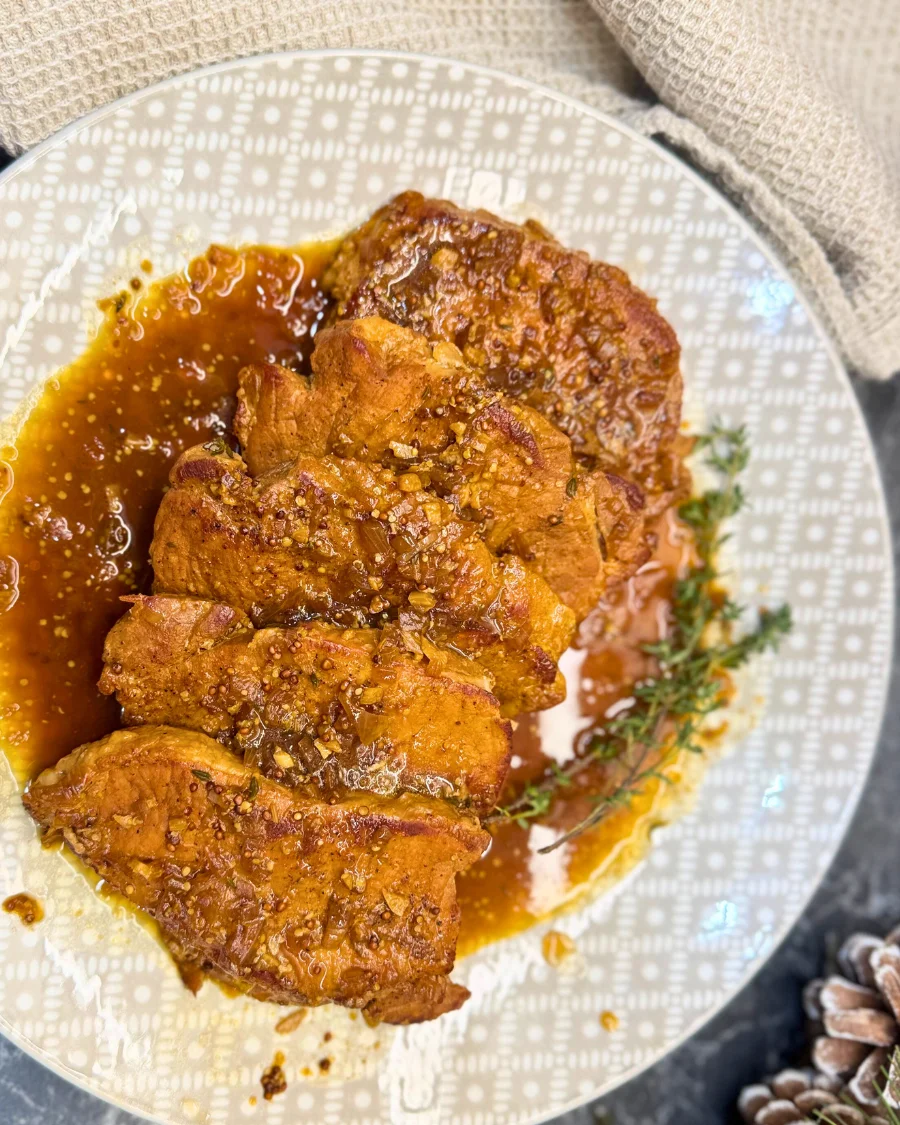 Braised pork in dark beer garnished with thyme and served in aromatic sauce