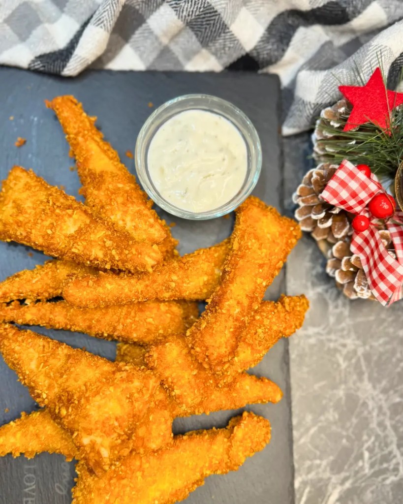 Top view of crunchy Crispy Chicken Tortilla Bites served with a small bowl of creamy sauce.