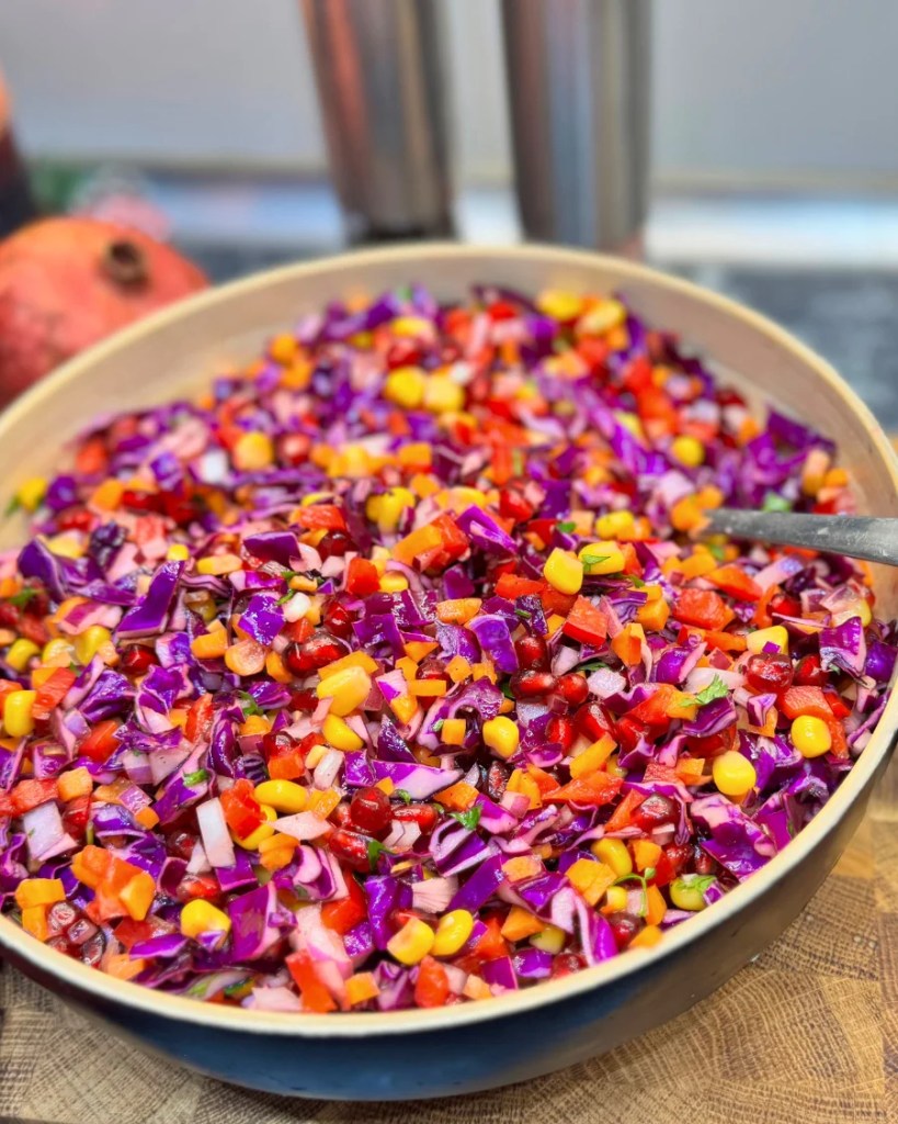 Healthy raw cabbage salad with pomegranate seeds and lemon sumac dressing
