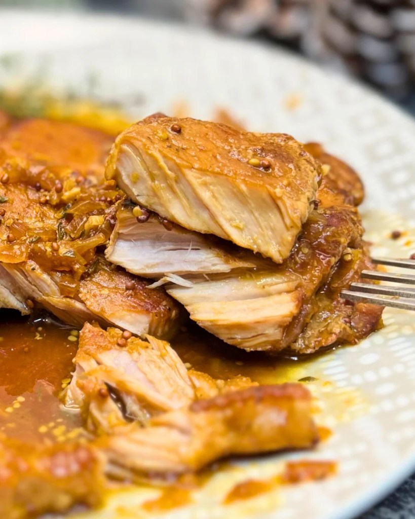 Juicy dark beer braised pork showing tender, fall-apart texture inside