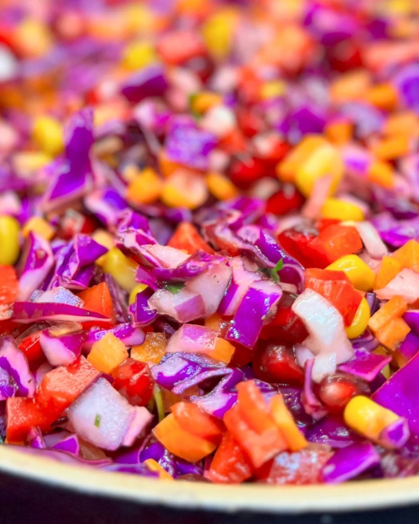 Close-up of antioxidant raw vegetable salad with purple cabbage and pomegranate