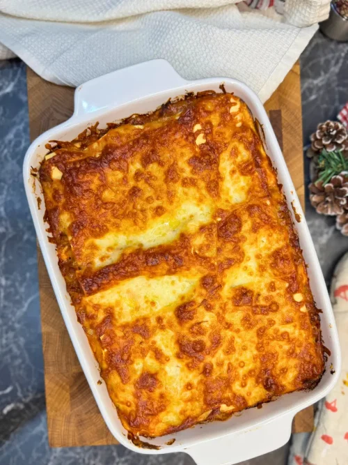 Easy homemade lasagna baked until golden and bubbly in a white ceramic baking dish