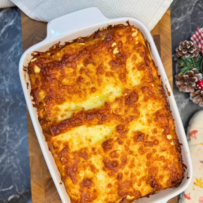Easy homemade lasagna baked until golden and bubbly in a white ceramic baking dish