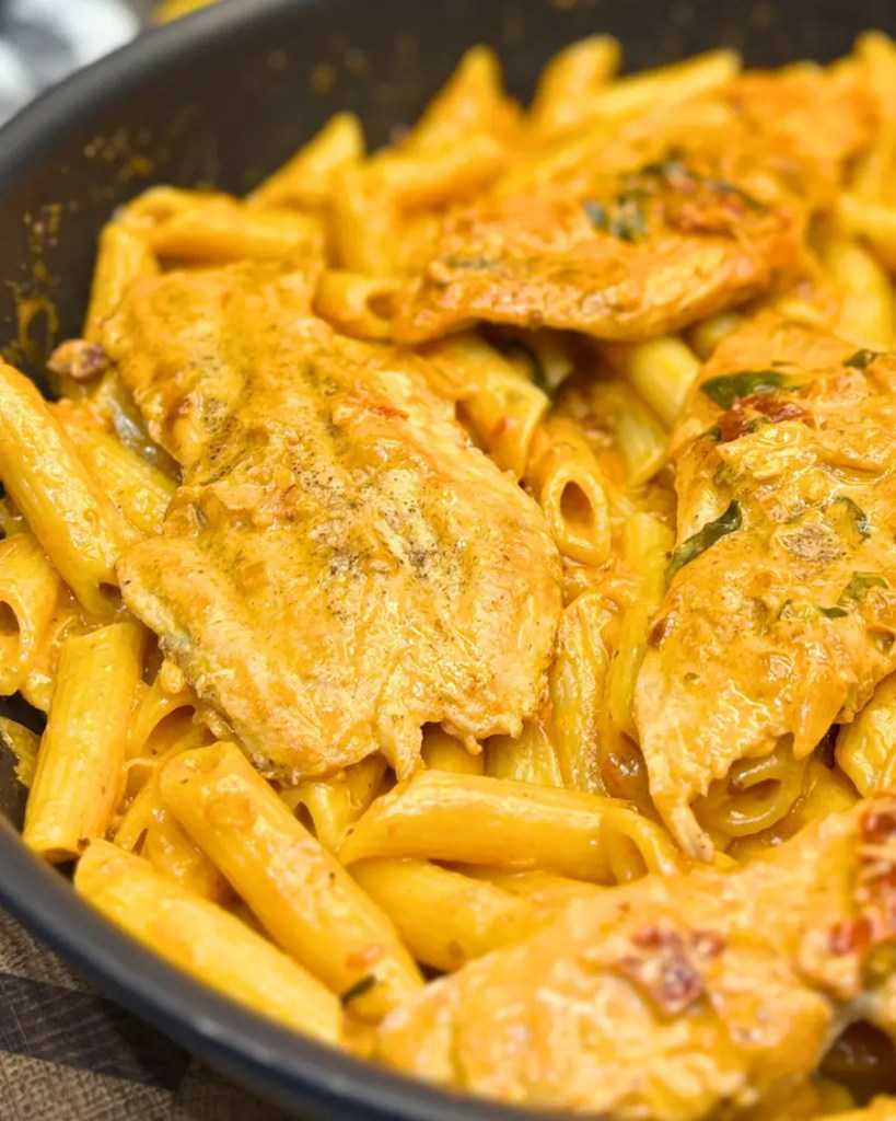 Close-up of Marry Me Chicken Pasta coated in rich creamy tomato Parmesan sauce