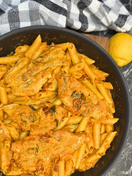 Marry Me Chicken Pasta with creamy sun-dried tomato sauce and crispy chili oil in a skillet