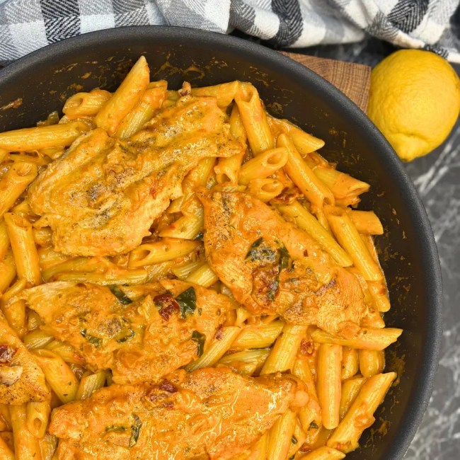 Marry Me Chicken Pasta with creamy sun-dried tomato sauce and crispy chili oil in a skillet