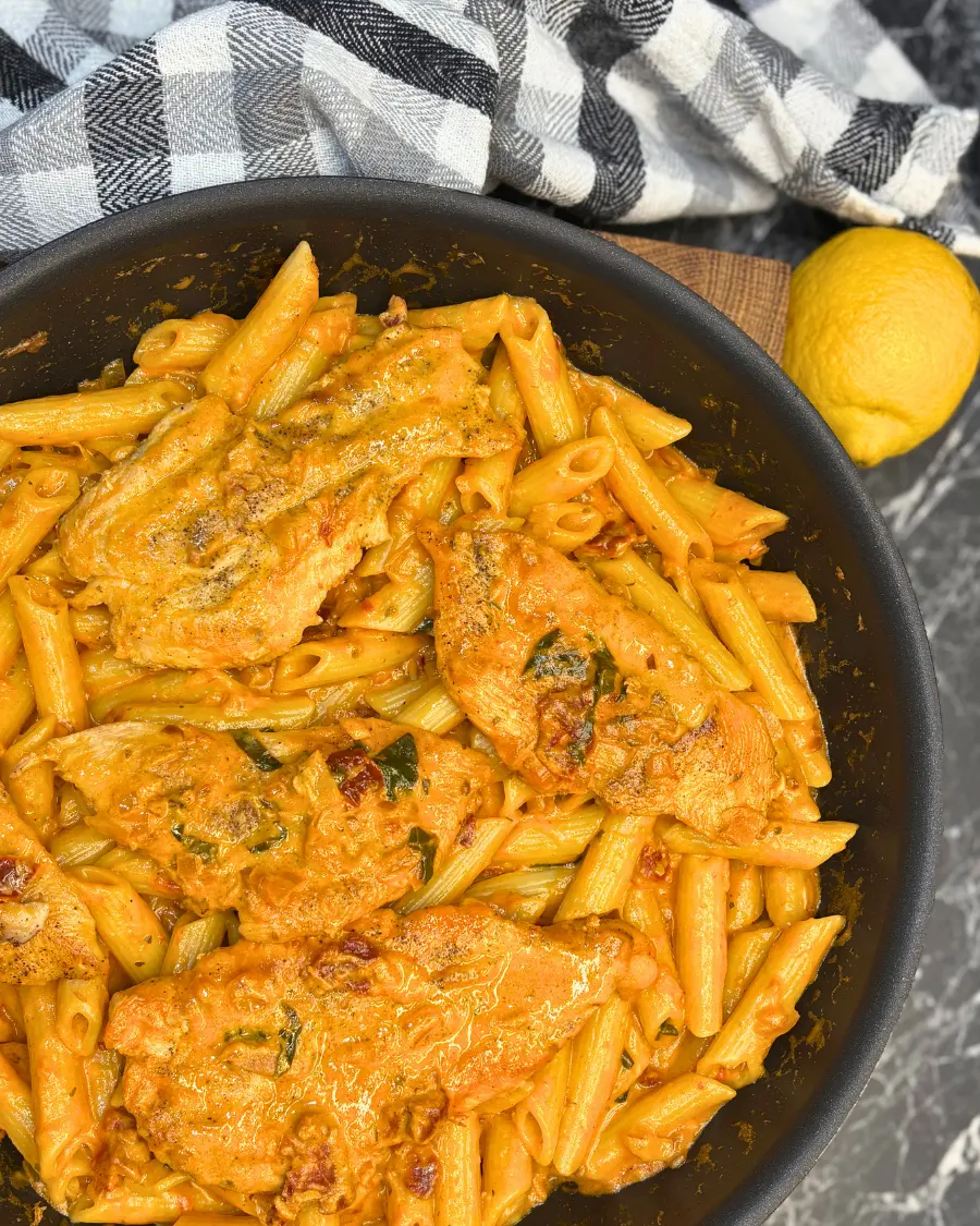 Marry Me Chicken Pasta with creamy sun-dried tomato sauce and crispy chili oil in a skillet