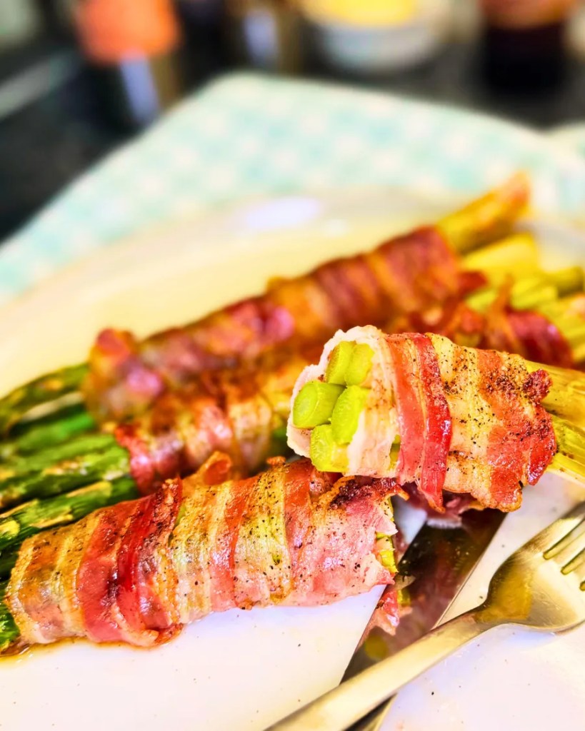 Close up of easy bacon wrapped asparagus recipe showing tender roasted asparagus inside crispy bacon.