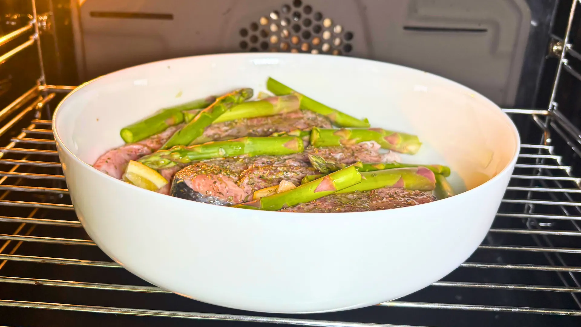 Trout steaks with asparagus and lemon baking in the oven at 200°C