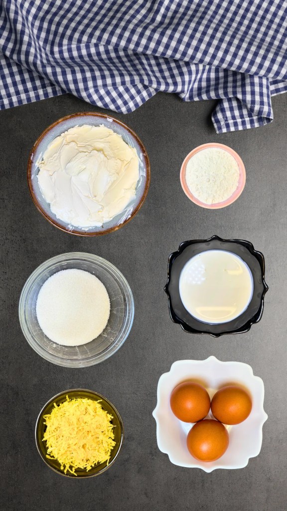 Ingredients for baked strawberry cheesecake filling including cream cheese, sugar, eggs, lemon zest, flour, and sour cream