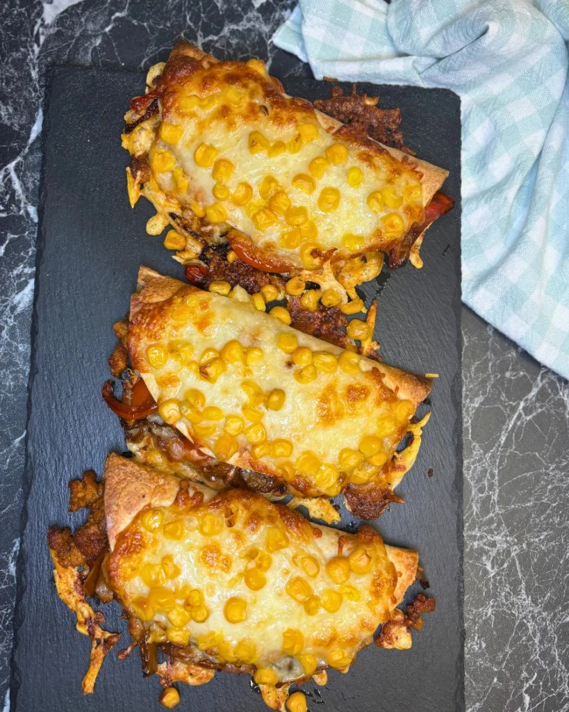 crispy baked chicken tacos with ground chicken, melted cheese, and corn baked in tortillas