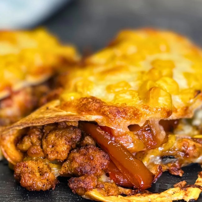 crispy baked taco stuffed with ground chicken, peppers, and melted cheese