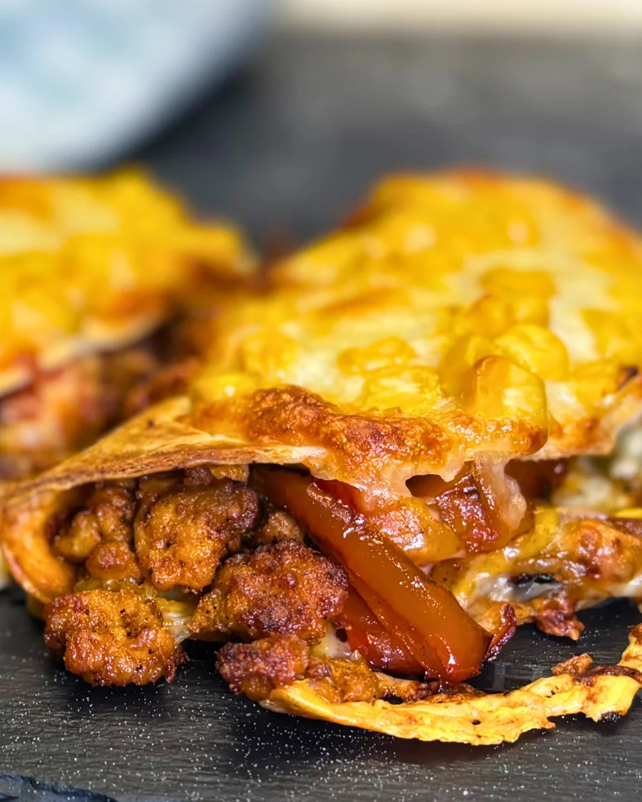 crispy baked taco stuffed with ground chicken, peppers, and melted cheese