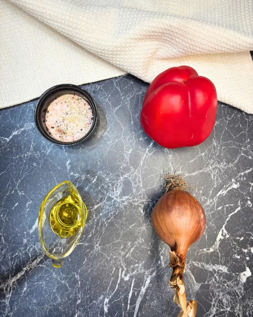 ingredients for crispy baked chicken tacos including bell pepper, onion, olive oil, and seasoning