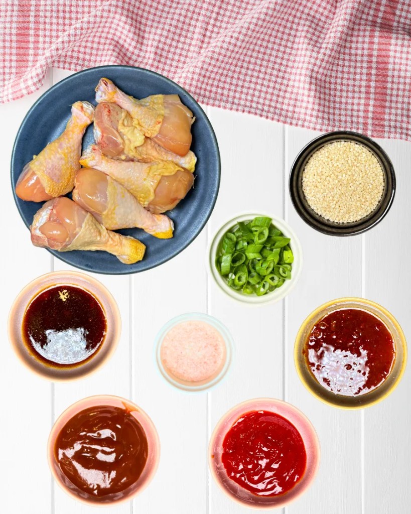 Ingredients for sticky air fryer chicken drumsticks including BBQ sauce teriyaki and sweet chili