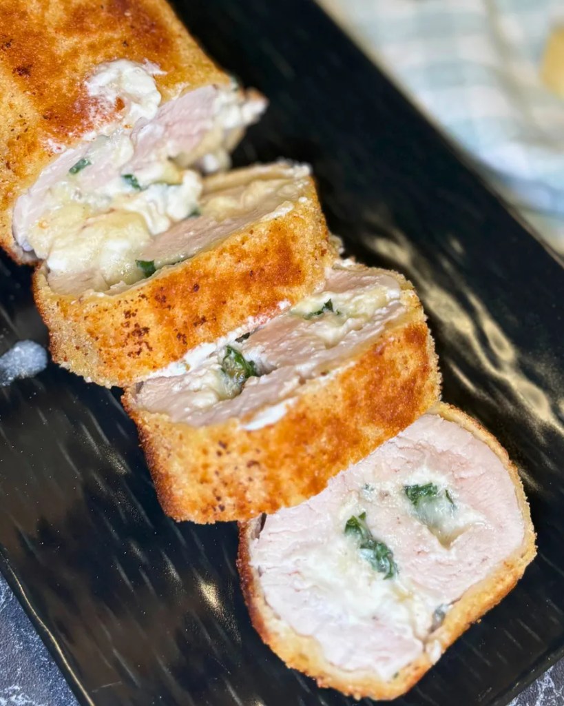 Close-up of stuffed turkey breast roll with cream cheese, spinach and parmesan
