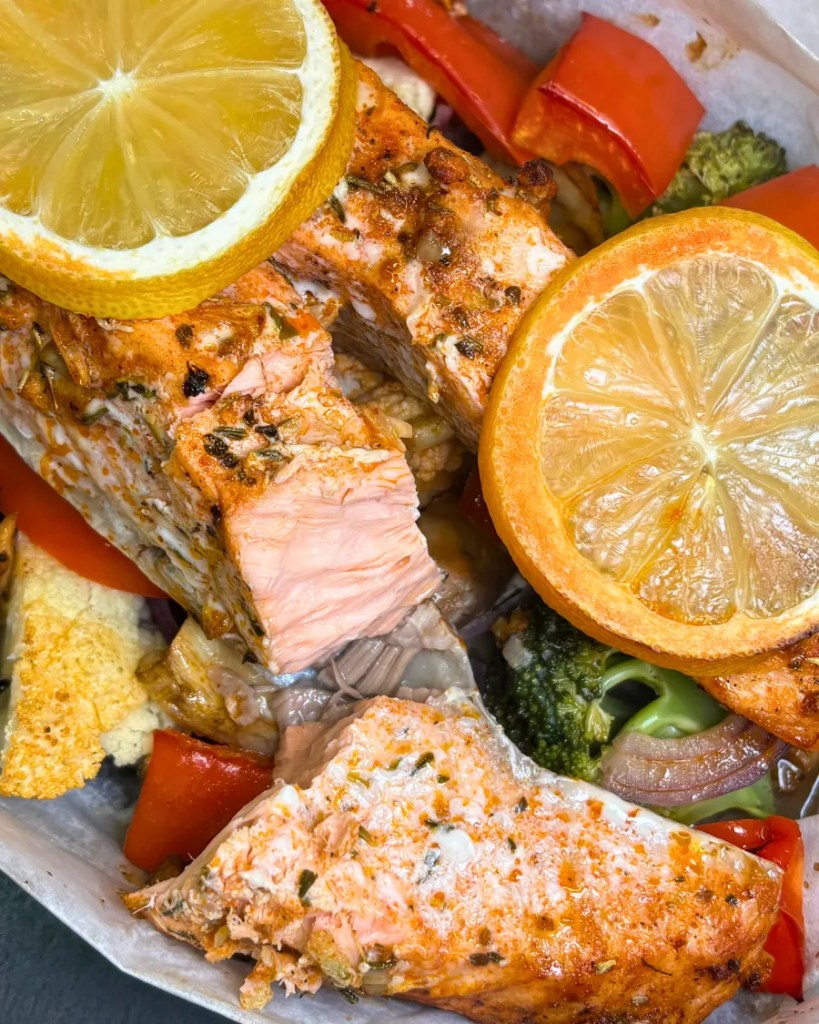 juicy baked salmon with vegetables cooked in parchment paper