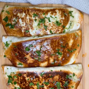 pan fried chicken tortillas with cheese and fresh parsley topping