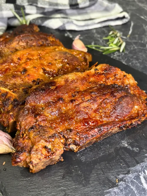 Air fryer pork steaks with golden crust and honey soy marinade on serving board