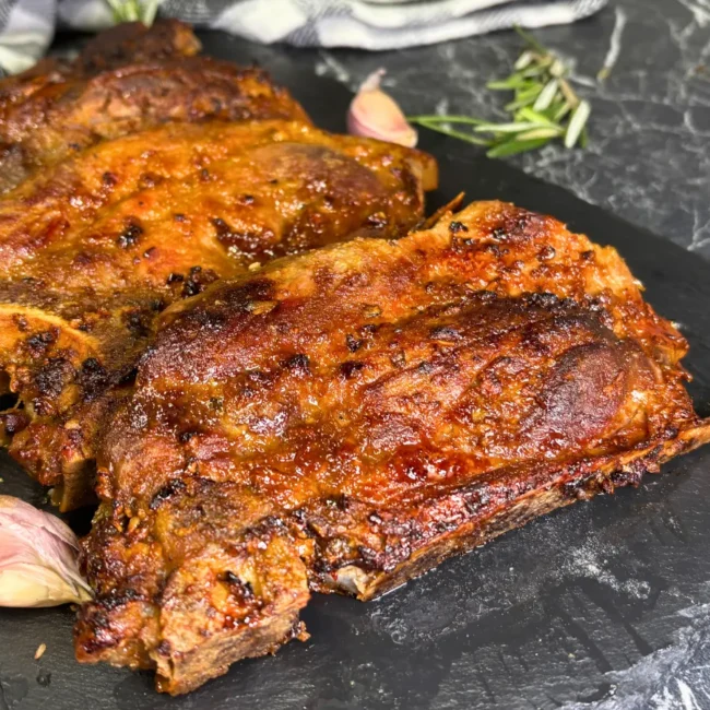 Air fryer pork steaks with golden crust and honey soy marinade on serving board