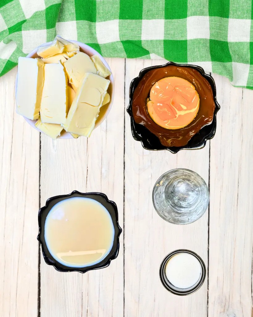 Ingredients for Kyiv cake cream including butter, egg yolks, condensed milk, and vanilla sugar