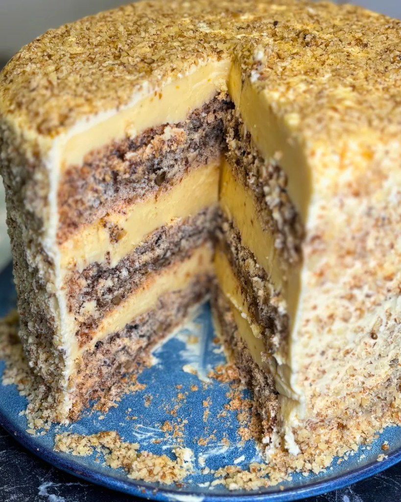 Close-up of Kyiv cake layers with nut meringue and rich cream