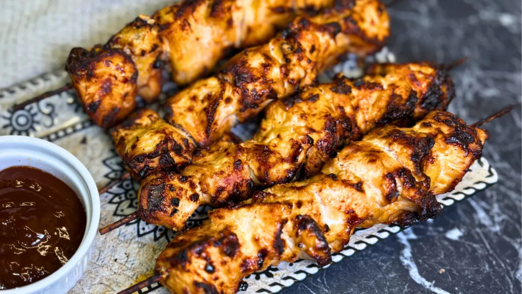 Homemade smoky chicken skewers cooked in the air fryer and served with dipping sauce