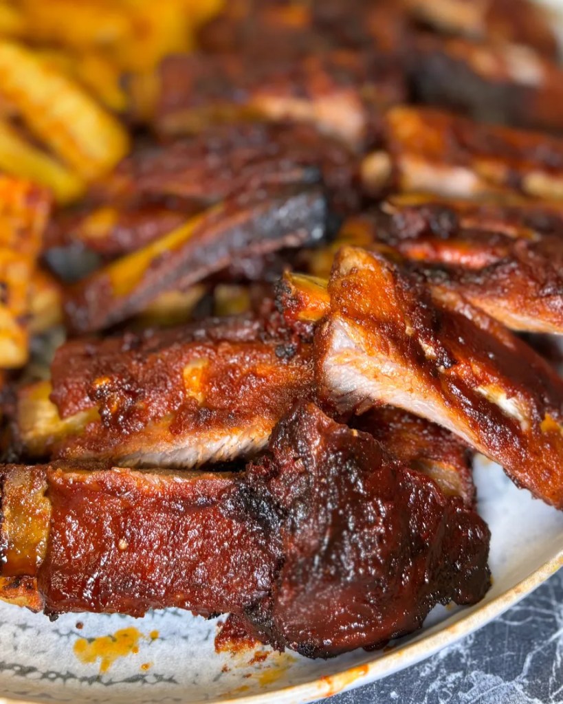 Tender oven baked pork ribs coated in a sticky honey soy glaze served with crispy seasoned potatoes.