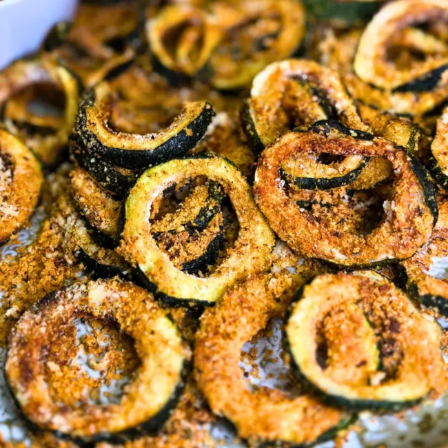 Close-up of crispy parmesan zucchini rings cooked in the air fryer until golden and crunchy