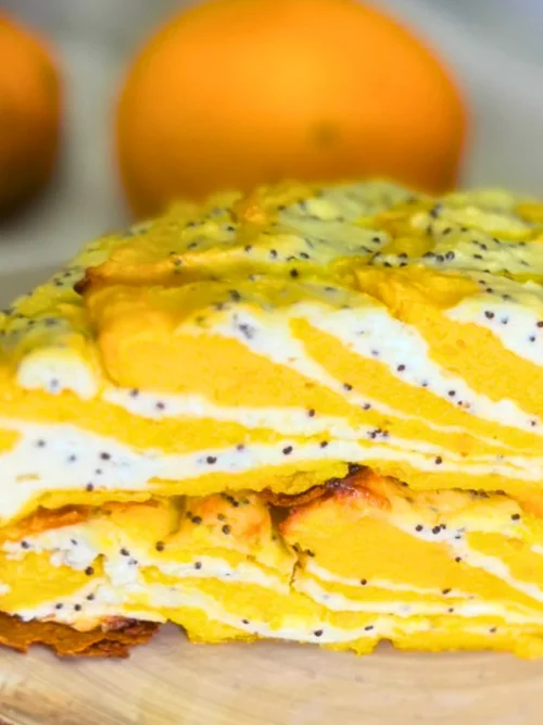 Close-up of marble pumpkin and cottage cheese casserole showing its soft texture, golden pumpkin layers, and creamy poppy seed filling.