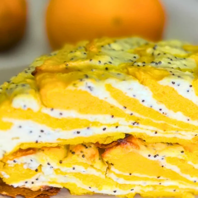 Close-up of marble pumpkin and cottage cheese casserole showing its soft texture, golden pumpkin layers, and creamy poppy seed filling.